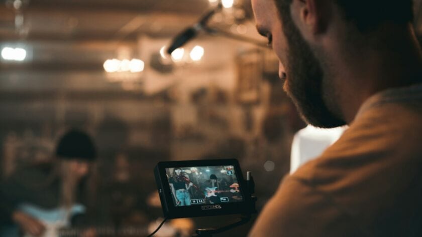 man holding black video camera